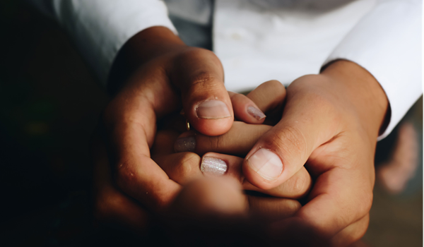 a hand holding a remote control